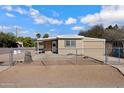 Tan single story home with chain link fence at 225 N 89Th St, Mesa, AZ 85207