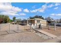 Tan single story home with chain link fence and gate at 225 N 89Th St, Mesa, AZ 85207