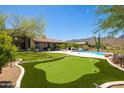 Private putting green adjacent to a beautiful home at 24724 N 119Th Pl, Scottsdale, AZ 85255