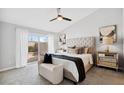 Main bedroom with king-size bed, patio access, and neutral decor at 8952 E Palm Ridge Dr, Scottsdale, AZ 85260