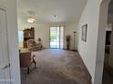 Living room with recliner, carpet, and sliding glass door at 2101 S Meridian Rd # 215, Apache Junction, AZ 85120