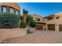 Stunning home exterior with double garage and desert landscaping at 10284 E Filaree Ln, Scottsdale, AZ 85262