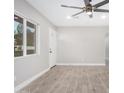 Bright and airy living room with wood-look tile flooring and ceiling fan at 2033 W Sunnyside Ave, Phoenix, AZ 85029
