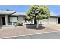 Front view of a condo with landscaping and a two car garage at 7950 E Keats Ave # 133, Mesa, AZ 85209