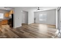 Open living room with laminate flooring and access to the kitchen at 3704 W Vivian Ct, Phoenix, AZ 85086