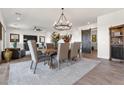 Elegant dining area with rustic farmhouse table and chandelier at 11249 N Blakely St, Surprise, AZ 85388