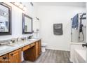 Clean bathroom with dual vanity, large mirror, and a walk-in shower at 6338 E Portia St, Mesa, AZ 85215