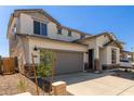 Two-story home with gray garage door at 17065 W Molly Ln, Surprise, AZ 85387