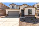 Two-story home with gray garage door at 17065 W Molly Ln, Surprise, AZ 85387