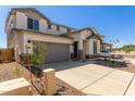 Two-story home with gray garage door at 17065 W Molly Ln, Surprise, AZ 85387