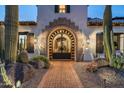 Elegant entry gate with ironwork and desert landscaping at 5842 E Redwing Rd, Paradise Valley, AZ 85253