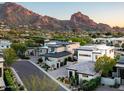 Aerial view of a luxury home community nestled against a mountain backdrop at 6296 N Lost Dutchman Dr, Paradise Valley, AZ 85253