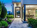 Entryway with modern glass door and meticulously landscaped walkway at 6296 N Lost Dutchman Dr, Paradise Valley, AZ 85253