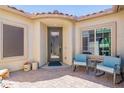 Inviting front entrance with two comfy chairs and a doormat at 5809 W Victory Ct, Florence, AZ 85132