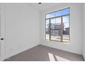 Bright bedroom with large window and neutral-toned carpet at 22782 E Stacey Rd, Queen Creek, AZ 85142