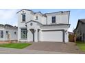 Two-story house with white exterior, gray tile roof, and a two-car garage at 22782 E Stacey Rd, Queen Creek, AZ 85142