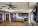 Gourmet kitchen with island, granite counters, and hardwood floors at 7175 E Camelback Rd # 704, Scottsdale, AZ 85251