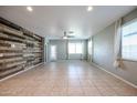 Spacious living room with tile floors, neutral walls, and large windows at 30948 W Columbus Ave, Buckeye, AZ 85396