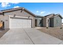 Modern farmhouse style home with gray siding and a white garage door at 37520 W Padilla St, Maricopa, AZ 85138