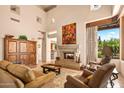 Spacious living room features a fireplace and large windows at 28080 N 101St St # 116, Scottsdale, AZ 85262