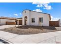 Modern stucco home with a two-car garage and desert landscaping at 37645 W Padilla St, Maricopa, AZ 85138