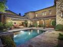 Inviting pool and spa area with flagstone patio and lush landscaping at 10287 E Diamond Rim Dr, Scottsdale, AZ 85255