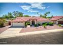 Single-story home with red tile roof and landscaped yard at 2119 N Lake Shore Dr, Casa Grande, AZ 85122