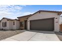 New single story home with a two-car garage and stone accents at 37607 W Padilla St, Maricopa, AZ 85138