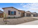 New single story home with a two-car garage and stone accents at 37607 W Padilla St, Maricopa, AZ 85138