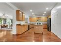 Spacious kitchen with hardwood floors, an island, and light wood cabinets at 3260 E Mead Dr, Gilbert, AZ 85298