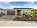 Single-story home with a gray garage door, light-colored stone, and desert landscaping at 13330 W Milton Dr, Peoria, AZ 85383