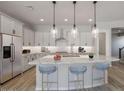 Modern kitchen with large island and stainless steel appliances at 23148 E Carriage Way, Queen Creek, AZ 85142