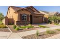 House exterior with landscaping and two-car garage at 23148 E Carriage Way, Queen Creek, AZ 85142