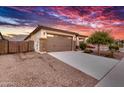 Single story home with attractive landscaping and two-car garage at 17135 W Diana Ave, Waddell, AZ 85355