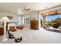Main bedroom with patio access and ample space for furniture at 15717 W Linksview Dr, Surprise, AZ 85374