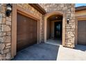 Home's entry with a two-car garage, pavers and stone accents at 4198 N Spyglass Dr, Florence, AZ 85132