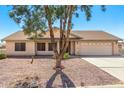 One-story home with desert landscaping and a two-car garage at 14360 S Cienega Ln, Arizona City, AZ 85123