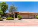 Tan two-story house with tile roof and three-car garage at 4055 N Recker Rd # 95, Mesa, AZ 85215