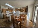 Kitchen features wood cabinets, island, and dining area at 650 N Hawes Rd # 4956, Mesa, AZ 85207