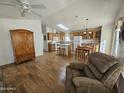 Open kitchen with island, wood cabinets and hardwood floors at 650 N Hawes Rd # 4956, Mesa, AZ 85207