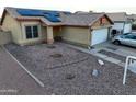 House front with solar panels, double garage, and landscaped yard at 11322 W Diana Ave, Peoria, AZ 85345