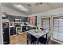 Kitchen with dark cabinets, stainless steel appliances, and breakfast nook at 11322 W Diana Ave, Peoria, AZ 85345