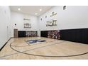 Indoor basketball court with hardwood flooring and seating at 4568 S Banning Dr, Gilbert, AZ 85297