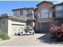 Two story home with golf cart in driveway at 3852 E Expedition Way, Phoenix, AZ 85050