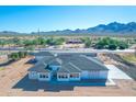 Aerial view of a new single-story home with a three-car garage and mountain views at 26761 S 181St Pl, Queen Creek, AZ 85142