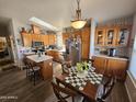 Kitchen with wooden cabinets, island, and dining area at 650 N Hawes Rd # 4507, Mesa, AZ 85207