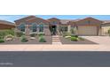 One-story home with a landscaped front yard and a large driveway at 12349 W Tyler Trl, Peoria, AZ 85383