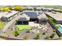 Aerial view of a house featuring a solar panel system, putting green, and pool at 12349 W Tyler Trl, Peoria, AZ 85383