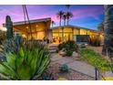 Mid-century modern home with desert landscaping, showcasing unique architectural details and beautiful sunset views at 8517 N 48Th Pl, Paradise Valley, AZ 85253