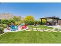 Landscaped backyard with fire pit and pergola at 21258 W Meadowbrook Ave, Buckeye, AZ 85396